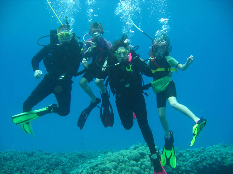 An underwater photo of four people scuba diving.