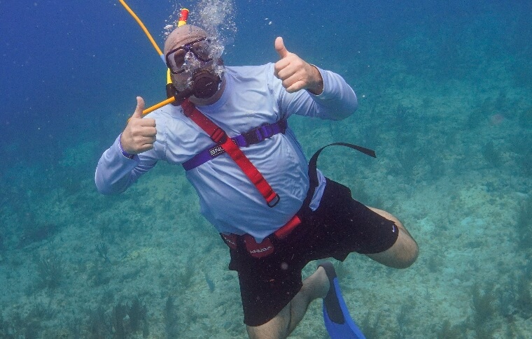 Scuba diver gesturing with two thumbs up to camera