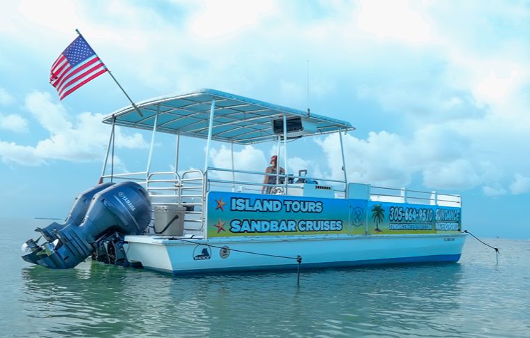 Pontoon boat with USA flag floating in sandbar